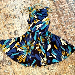 Gorgeous mini dress with flare below the waist. Sleeveless Back zipper